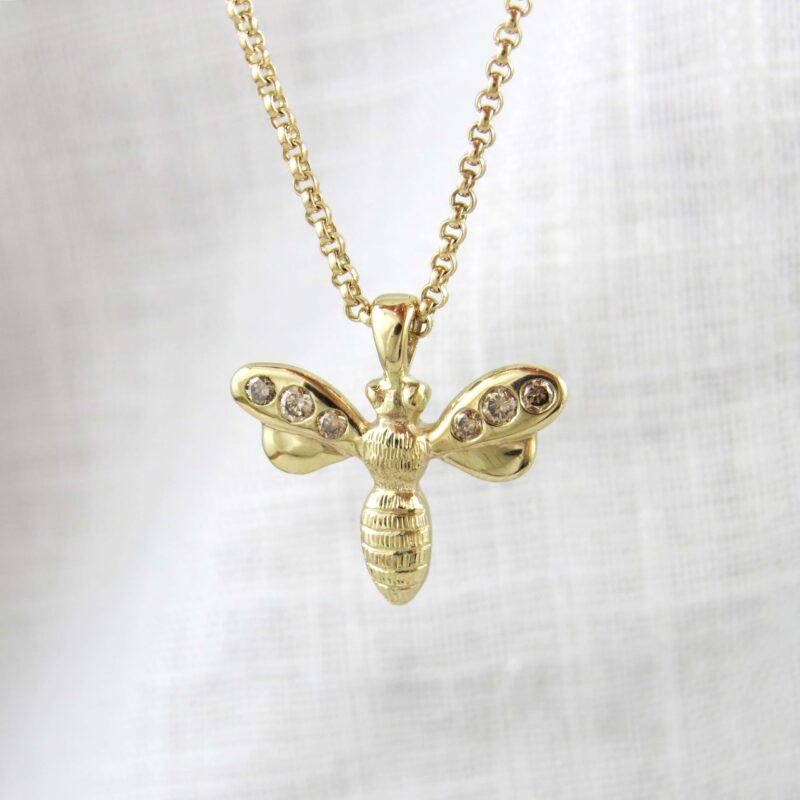 Diamond set bee pendant in gold