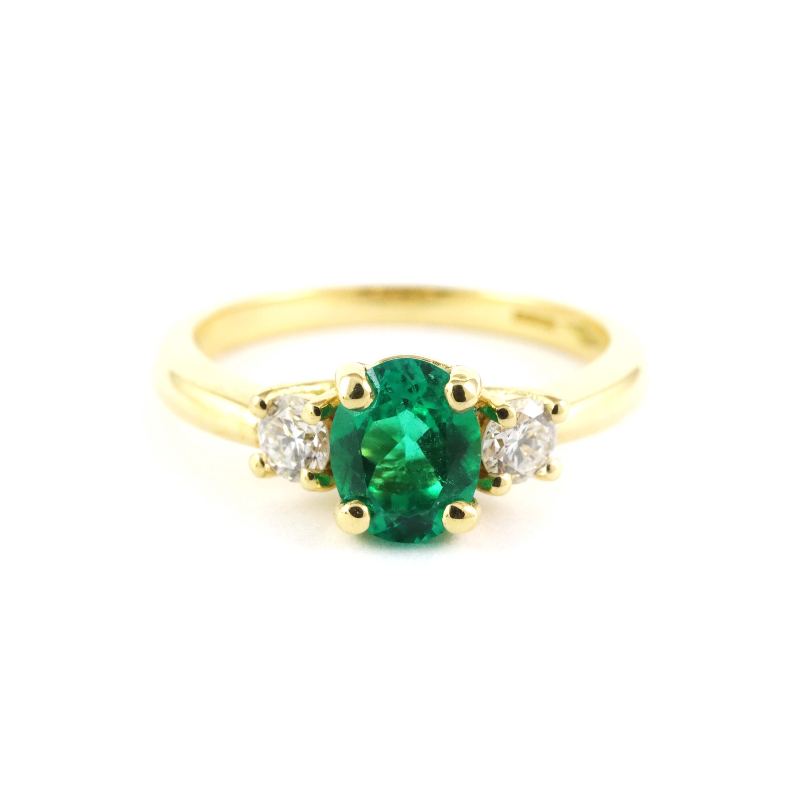 Emerald and diamond trilogy ring in gold